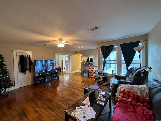 living room featuring ceiling fan, french doors, and dark hardwood / wood-style flooring