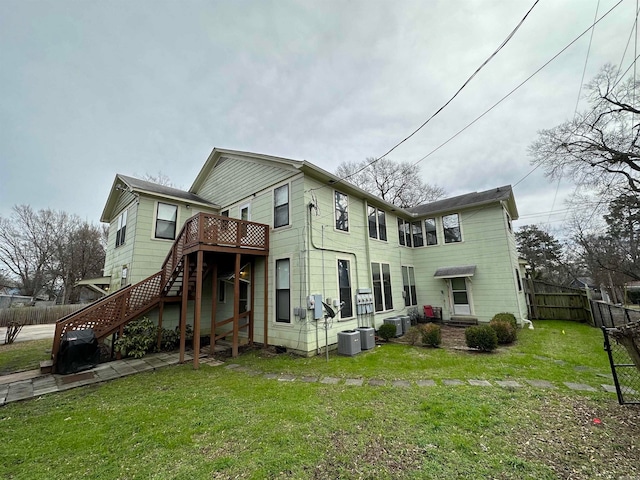 exterior space with a wooden deck, central AC unit, and a front yard