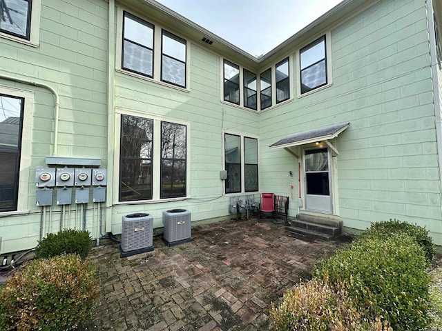 back of property featuring central air condition unit