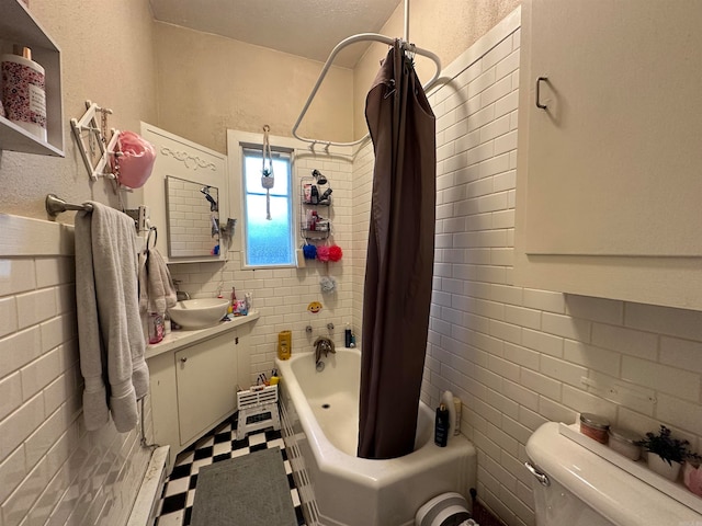 full bathroom with shower / tub combo, vanity, tile floors, and toilet