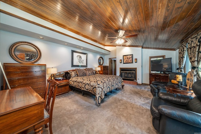 carpeted bedroom featuring wooden ceiling, ceiling fan, crown molding, a fireplace, and lofted ceiling