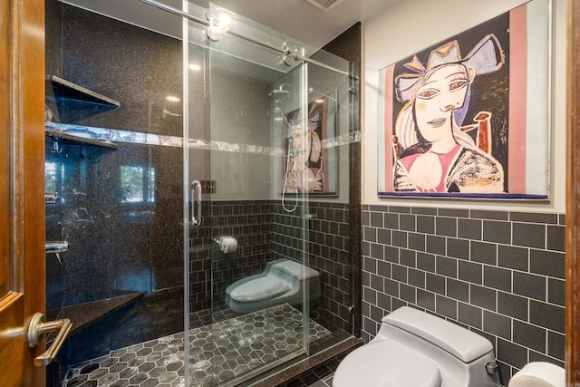 bathroom featuring tile walls, toilet, and an enclosed shower