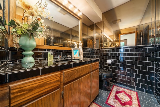 interior space featuring toilet, vanity, tasteful backsplash, tile walls, and tile floors