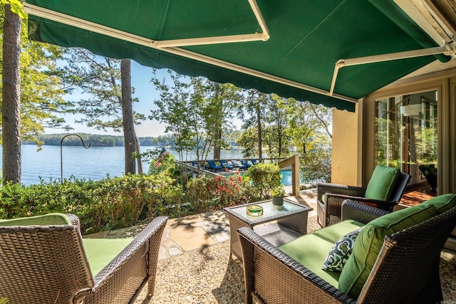 view of terrace featuring an outdoor hangout area and a water view