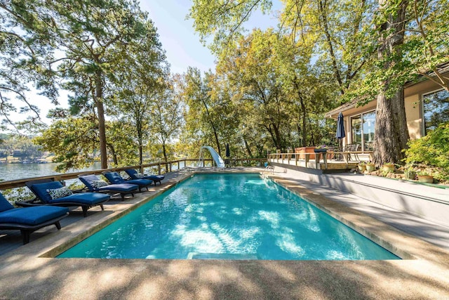 view of pool with a patio area and a water slide