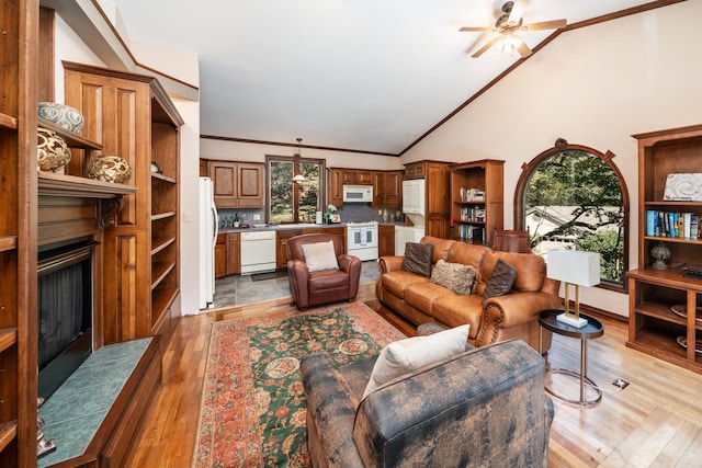 tiled living room featuring high vaulted ceiling, crown molding, and ceiling fan