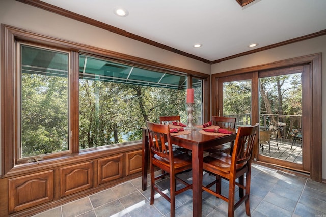 tiled dining room featuring ornamental molding