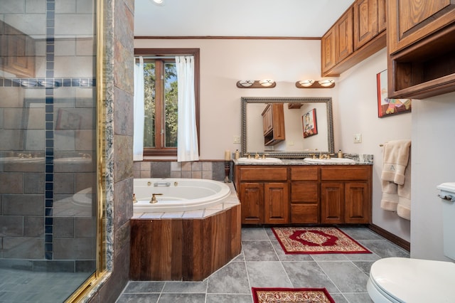 full bathroom featuring toilet, double sink, vanity with extensive cabinet space, shower with separate bathtub, and tile floors