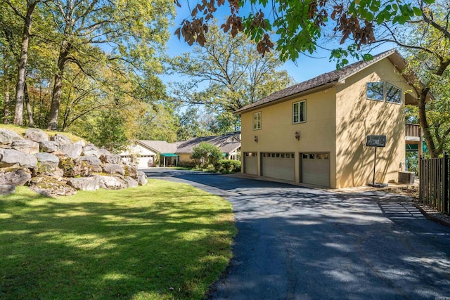 view of property exterior featuring central AC unit, a garage, and a yard