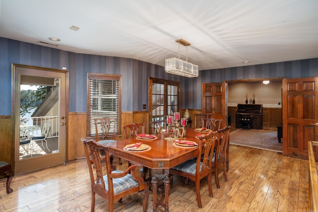 dining room with an inviting chandelier and light hardwood / wood-style flooring