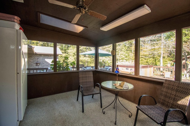 sunroom featuring ceiling fan and lofted ceiling