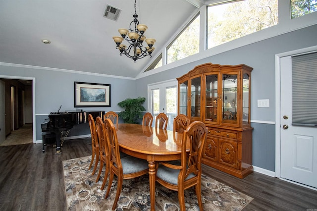 dining room with a notable chandelier, dark wood-type flooring, and high vaulted ceiling