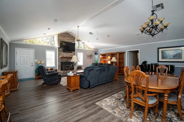 dining space with lofted ceiling, brick wall, a fireplace, and dark hardwood / wood-style floors