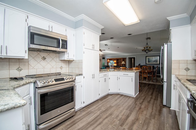 kitchen featuring appliances with stainless steel finishes, tasteful backsplash, dark wood-type flooring, and white cabinets