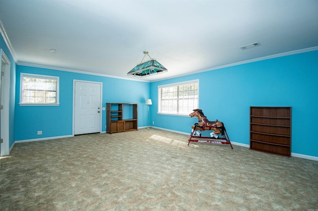 unfurnished room featuring crown molding, carpet flooring, and plenty of natural light