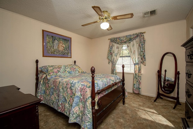 carpeted bedroom featuring a textured ceiling and ceiling fan