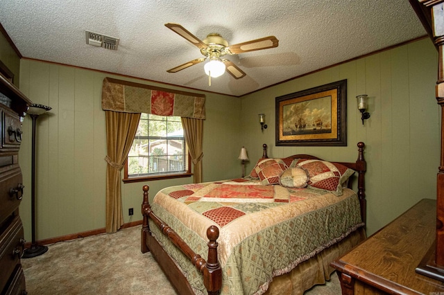 carpeted bedroom featuring ceiling fan and a textured ceiling