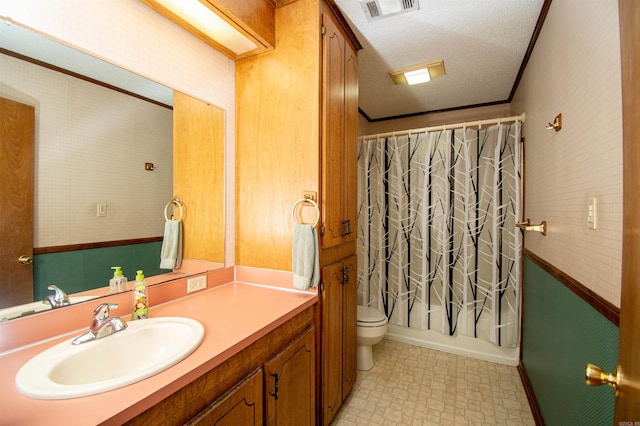 bathroom featuring toilet, a textured ceiling, large vanity, and tile flooring