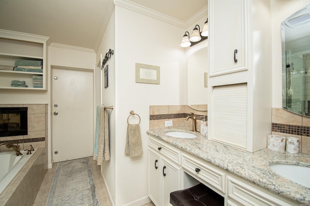 bathroom featuring a tiled fireplace, tile floors, double vanity, tiled tub, and ornamental molding