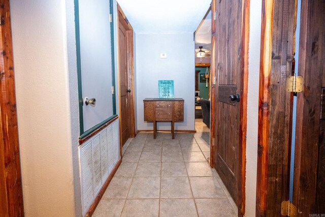 hall featuring light tile flooring