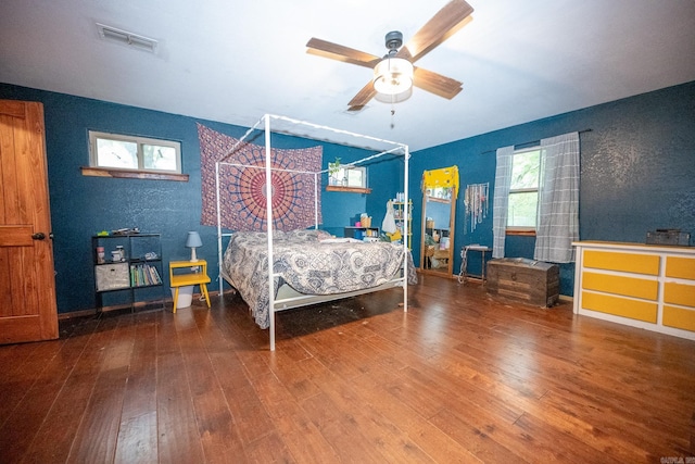 bedroom with ceiling fan and dark hardwood / wood-style flooring