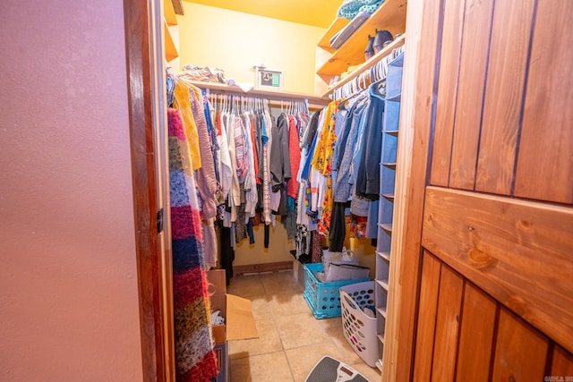 walk in closet featuring light tile floors