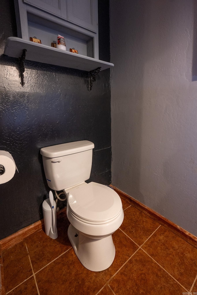 bathroom featuring tile flooring and toilet