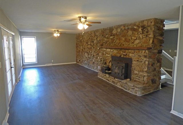 unfurnished living room featuring dark hardwood / wood-style floors, a fireplace, ceiling fan, and french doors