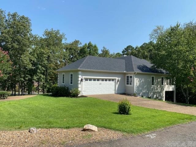 view of front of home with a garage and a front yard