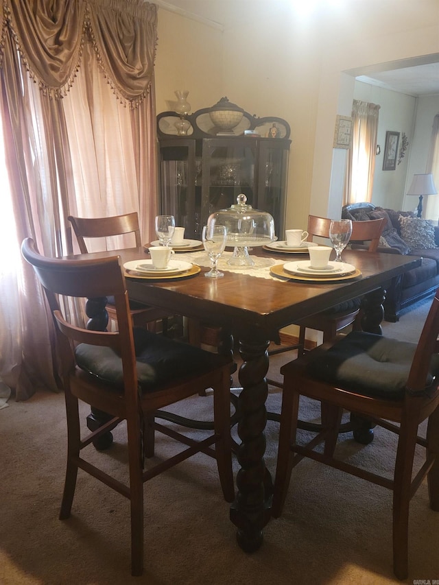 dining area featuring dark colored carpet