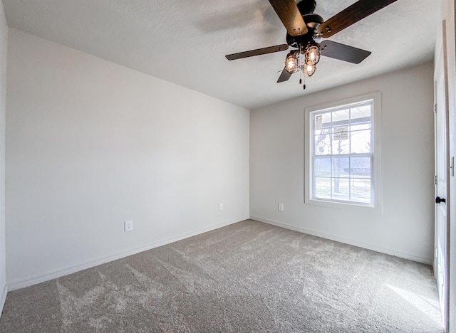 empty room with carpet flooring and ceiling fan