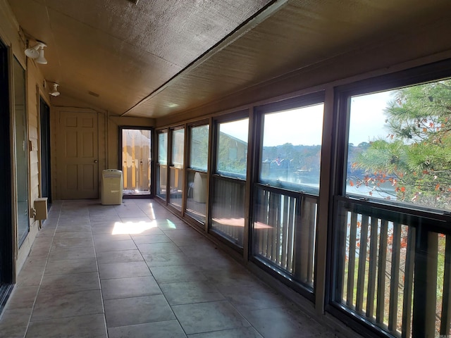 unfurnished sunroom featuring lofted ceiling