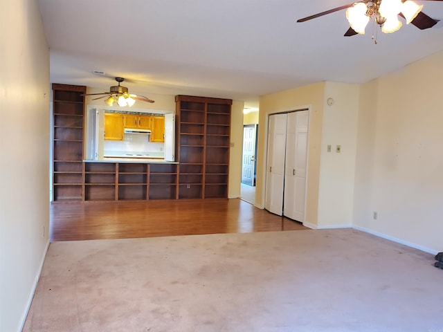 unfurnished living room with ceiling fan and light hardwood / wood-style flooring