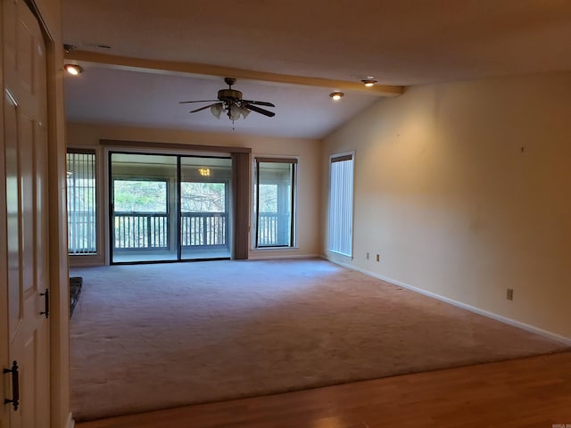 spare room featuring hardwood / wood-style floors, vaulted ceiling with beams, and ceiling fan