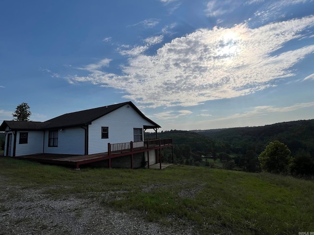 view of property exterior featuring a deck