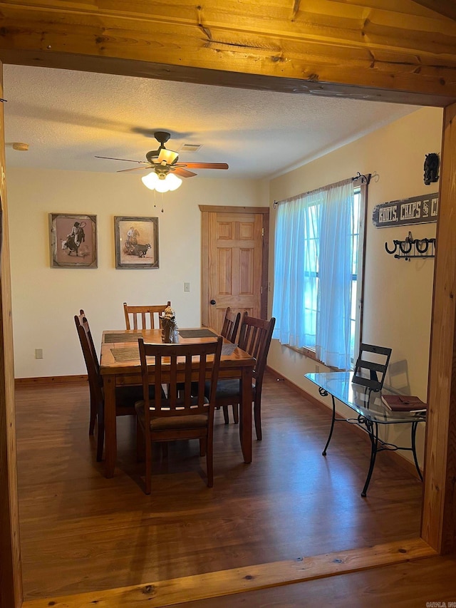 dining area featuring a textured ceiling, dark hardwood / wood-style flooring, and ceiling fan