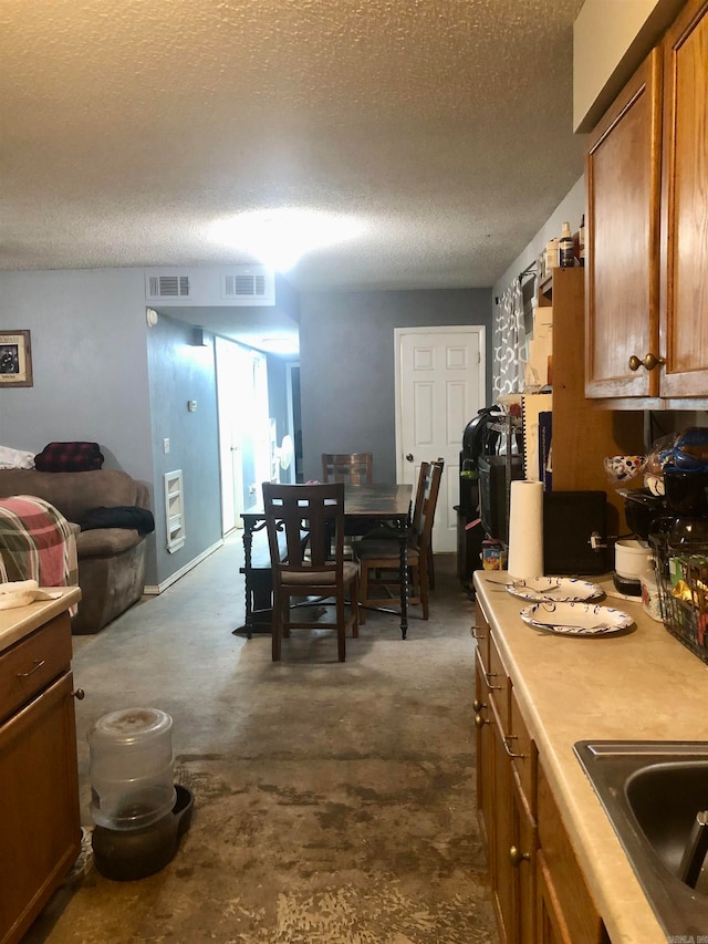 kitchen with a textured ceiling and sink