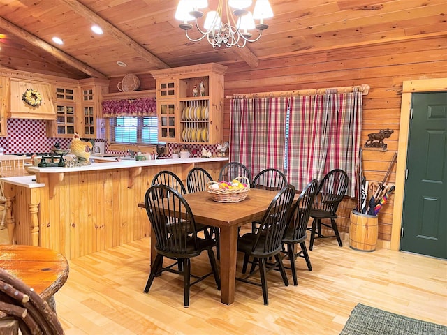 dining room featuring lofted ceiling with beams, an inviting chandelier, wooden ceiling, and light hardwood / wood-style flooring