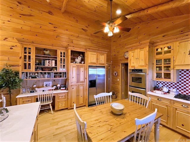 kitchen with beamed ceiling, ceiling fan, wooden ceiling, and stainless steel appliances