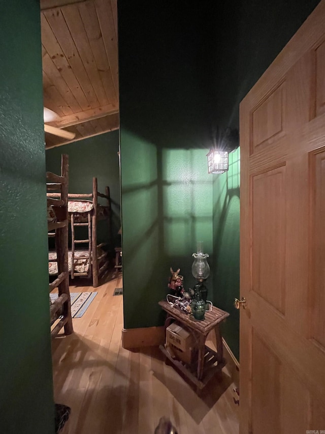 hallway with wood ceiling and light hardwood / wood-style flooring