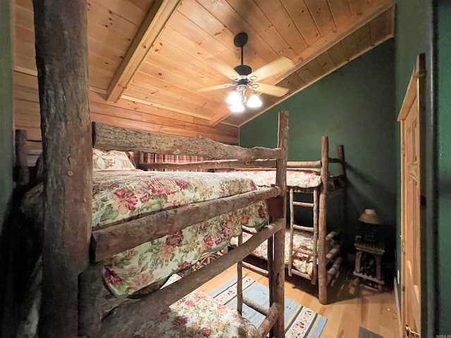bedroom featuring vaulted ceiling with beams, ceiling fan, light hardwood / wood-style flooring, and wood ceiling
