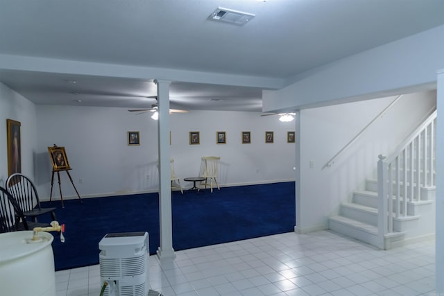 interior space featuring light tile patterned floors and ceiling fan