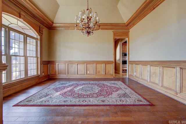 interior space featuring ornamental molding, an inviting chandelier, and hardwood / wood-style flooring