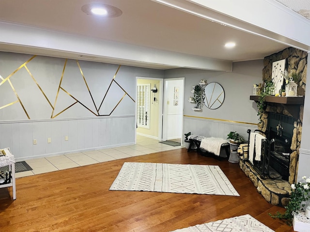interior space featuring wainscoting, a fireplace, wood finished floors, and recessed lighting