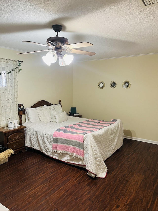 bedroom featuring a textured ceiling, ceiling fan, wood finished floors, and crown molding
