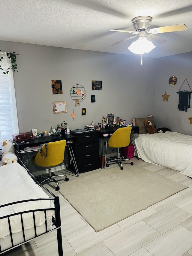 bedroom featuring a textured ceiling and a ceiling fan