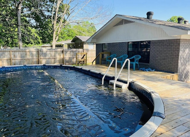 view of swimming pool with fence, a fenced in pool, and a patio