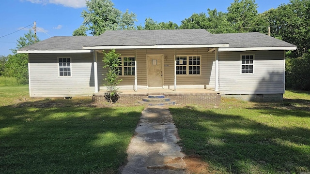 ranch-style home featuring covered porch and a front yard