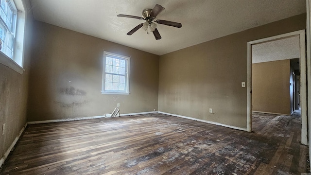 10085 James Dr, Havana, AR 72842 - spare room featuring a textured ceiling, dark hardwood / wood-style floors, and ceiling fan