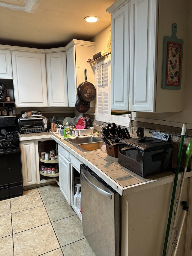 kitchen with white cabinetry, black range with gas cooktop, sink, dishwasher, and light tile patterned floors